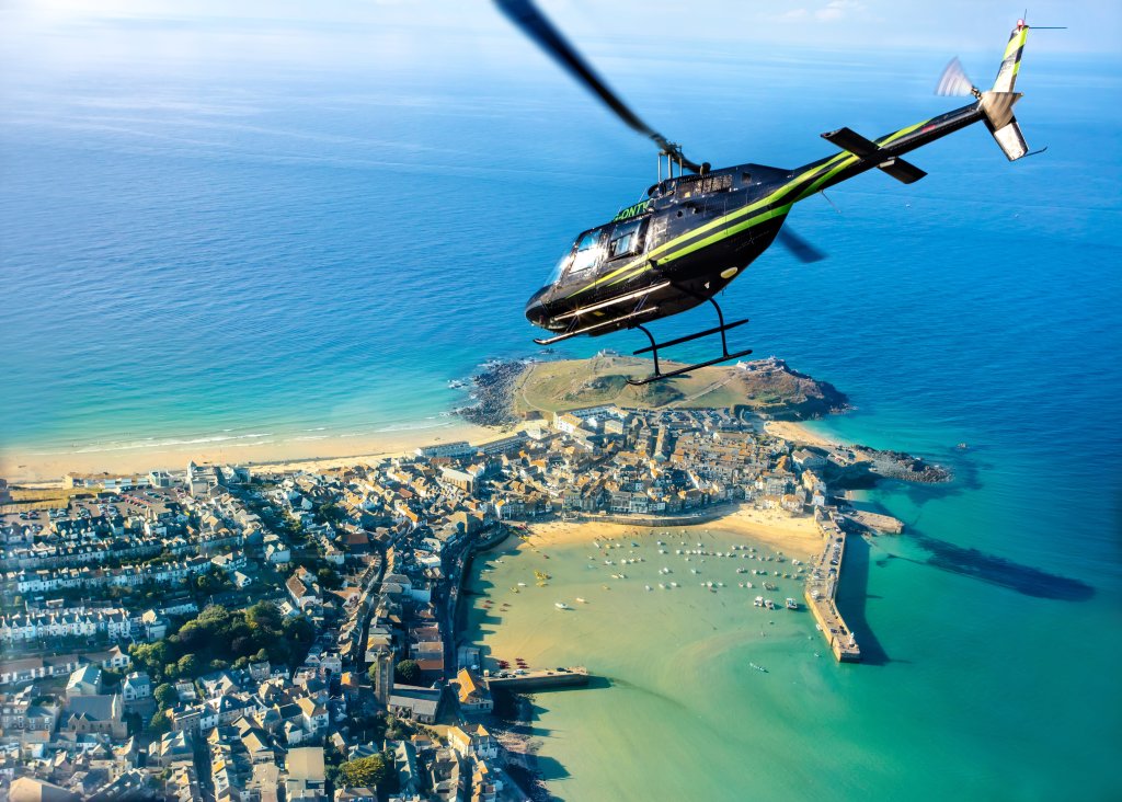 An image of a helicopter flying over St Ives in the UK.